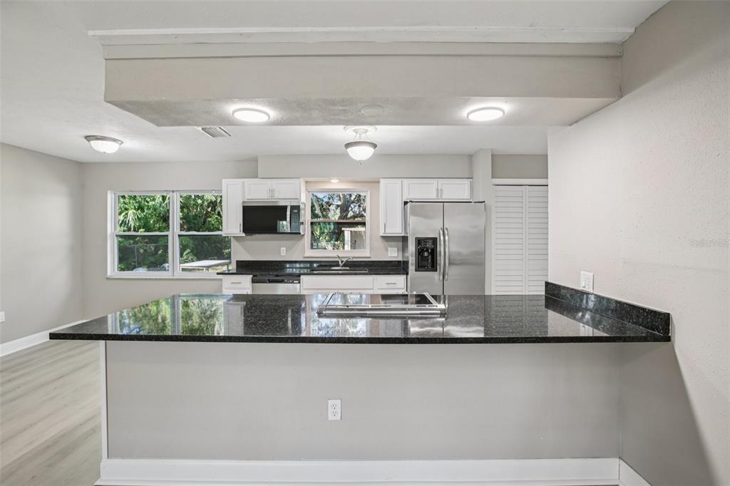 204 East Shell Point Road Ruskin, FL 33570 - Photo 5 of 48 a view of a kitchen with stainless steel appliances granite countertop a refrigerator a stove and a sink