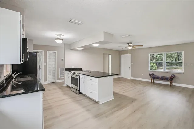 a view of kitchen with sink and wooden floor
