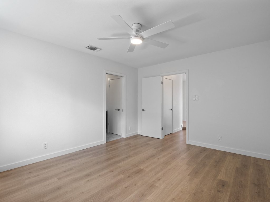 6902 Meadow Run Austin, TX 78745 - Photo 13 of 33 a view of an empty room with wooden floor