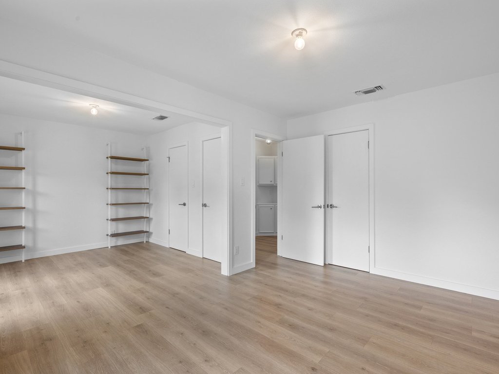 6902 Meadow Run Austin, TX 78745 - Photo 19 of 33 a view of a room with walk in closet and empty racks