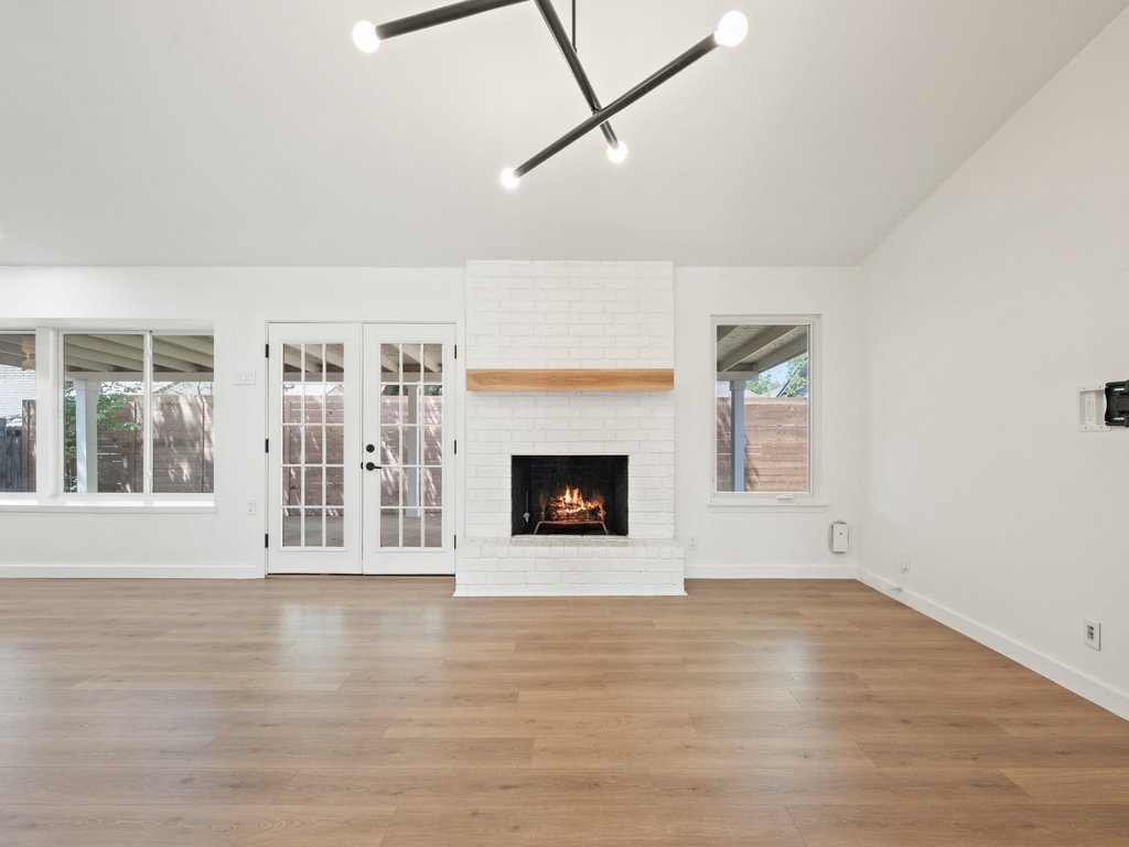 6902 Meadow Run Austin, TX 78745 - Photo 3 of 33 a view of a room with wooden floor and a fireplace
