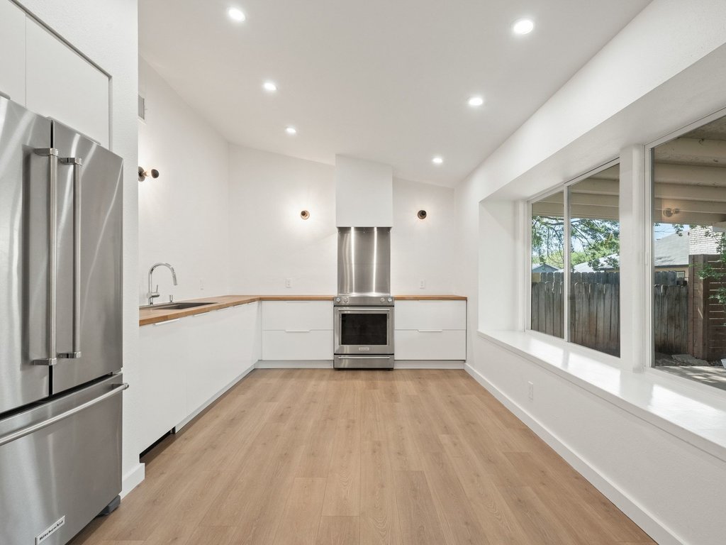 6902 Meadow Run Austin, TX 78745 - Photo 5 of 33 a view of a kitchen with a sink and refrigerator