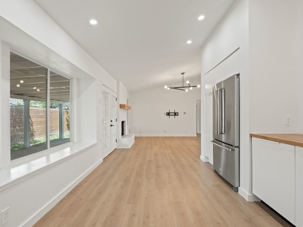 6902 Meadow Run Austin, TX 78745 - Photo 10 of 33 a view of empty room with wooden floor and fan