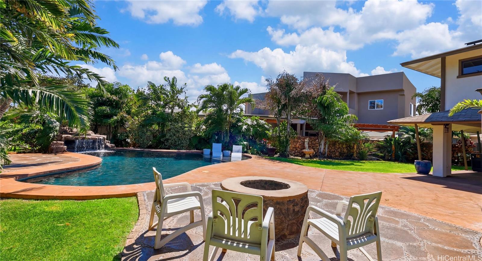 91-779 Fort Weaver Road Ewa Beach, HI 96706 - Photo 21 of 25 Custom outdoor entertainment area featuring a built-in stone fire pit right beside the pool.