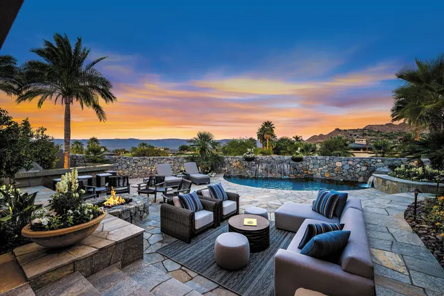 a view of a patio with couches fire pit and a patio