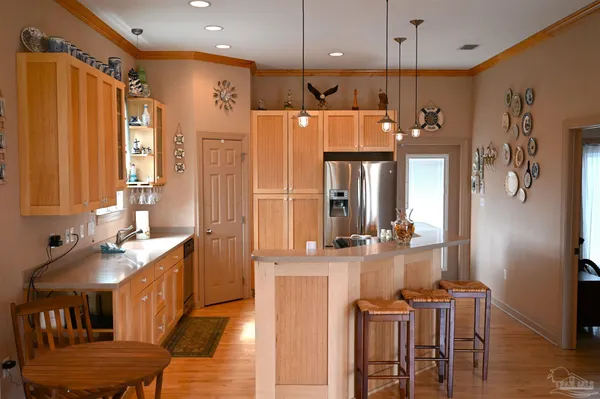 a kitchen with stainless steel appliances granite countertop a refrigerator a sink and a stove