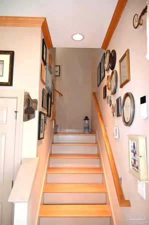 a bedroom with a bed a chandelier and dresser