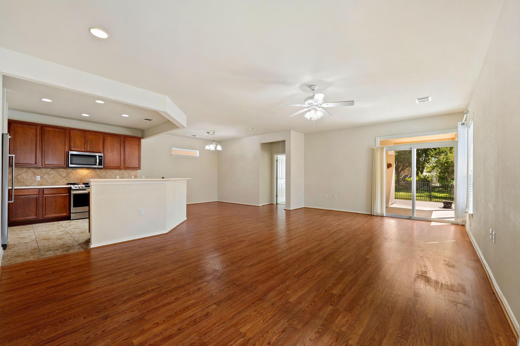 520 Mill Pond Path Georgetown, TX 78633 - Photo 38 of 38 An open floorplan seamlessly connects the well-appointed kitchen with the main living area, leading to a sun-drenched patio.