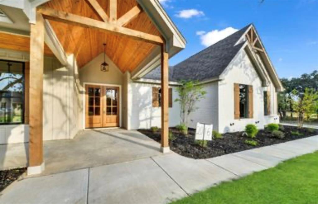2016 Forest Bridge Azle, TX 76020 - Photo 5 of 16 Property entrance with covered porch, stucco siding, and french doors