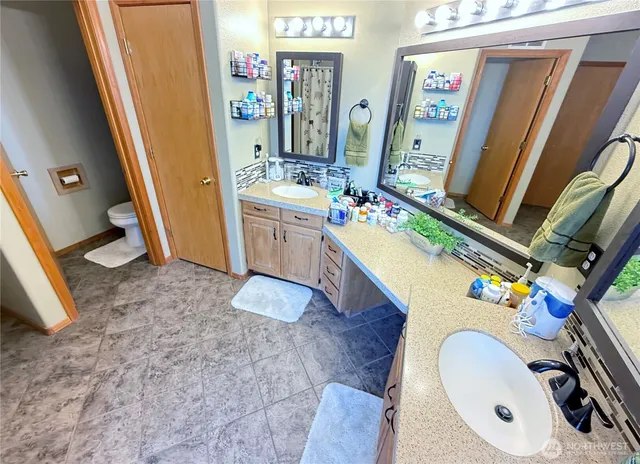a bathroom with a sink a mirror and shower
