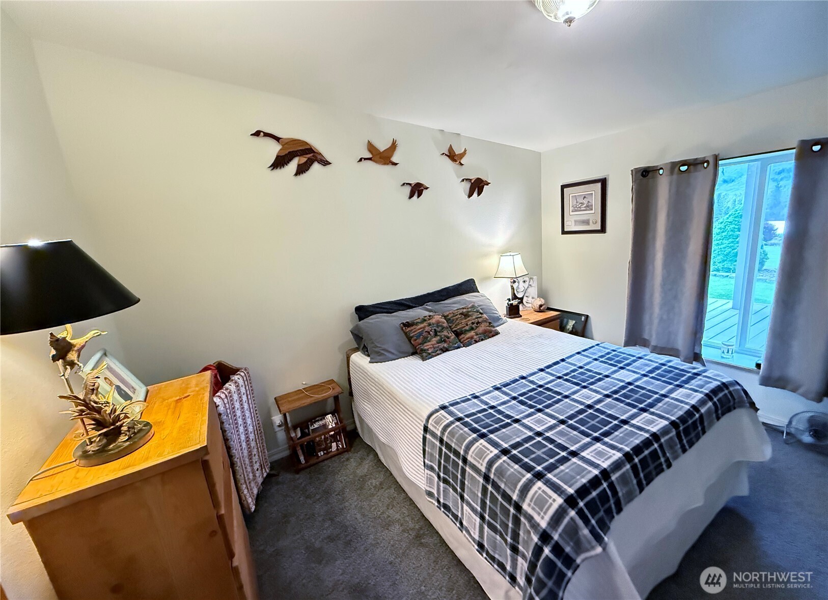 92 Crumbacher Road Tonasket, WA 98855 - Photo 18 of 40 a bedroom with a bed and wooden floor