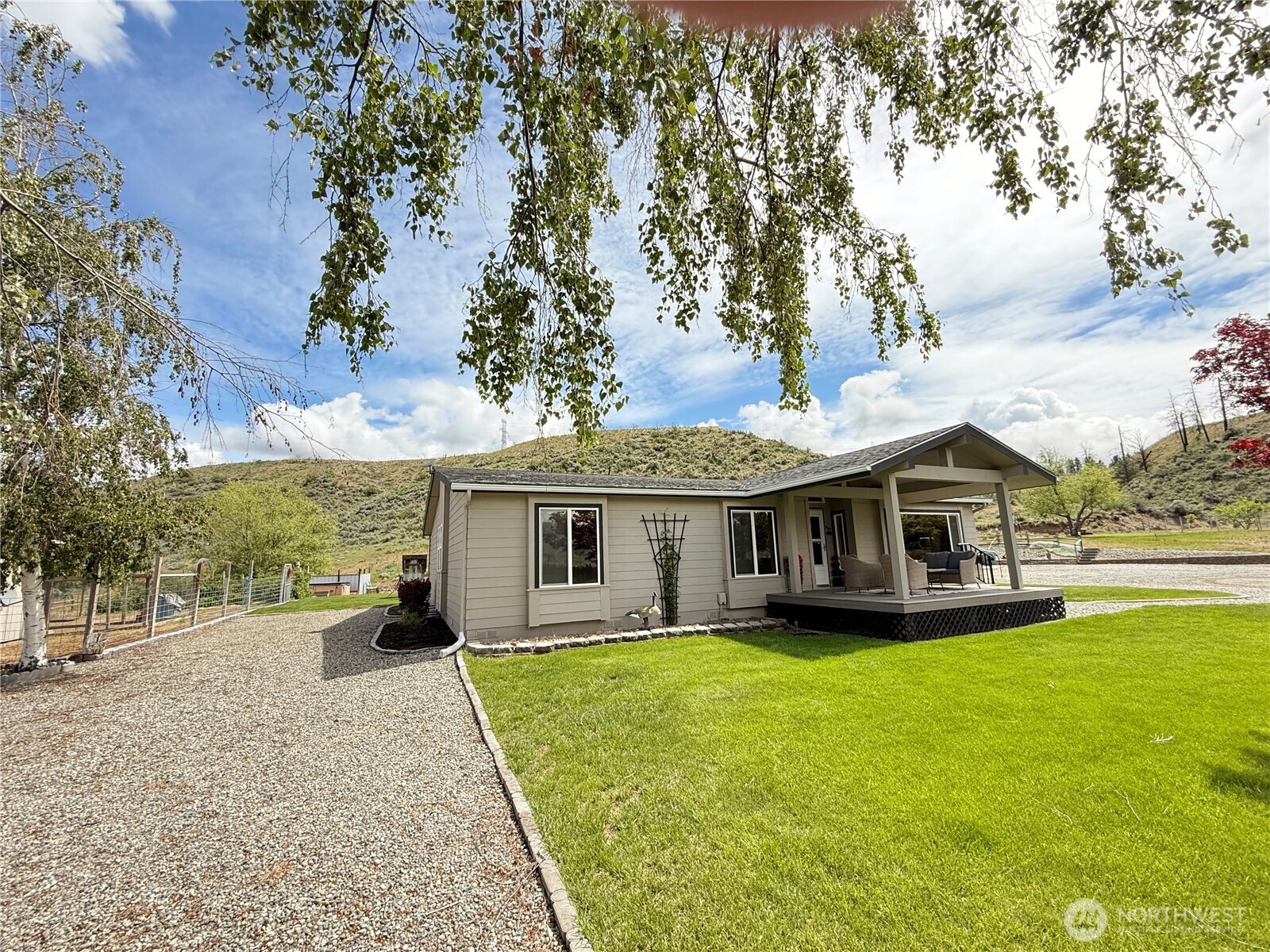 92 Crumbacher Road Tonasket, WA 98855 - Photo 2 of 40 a view of a house with a garden and trees