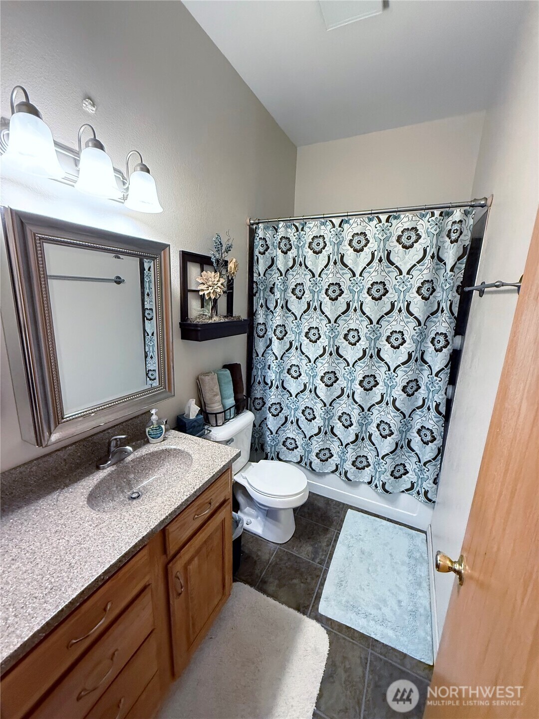 92 Crumbacher Road Tonasket, WA 98855 - Photo 22 of 40 a bathroom with a granite countertop sink and a mirror
