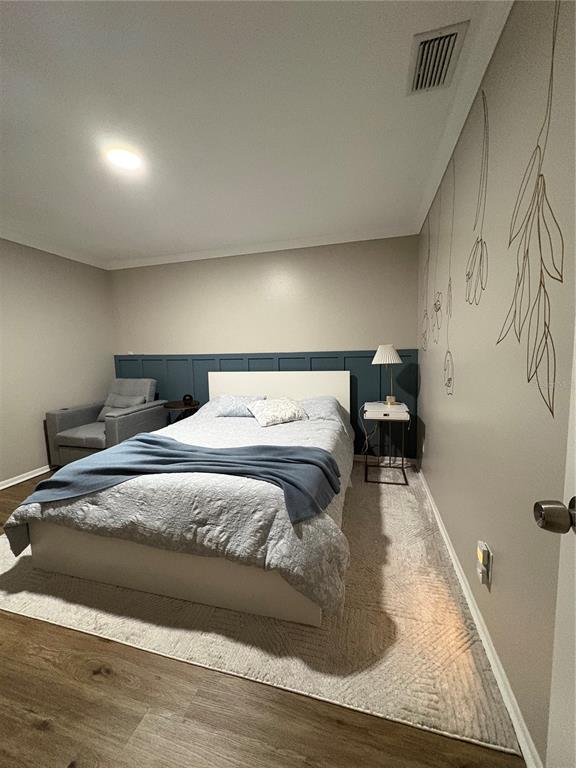 1500 Gay Road, Unit 20D Winter Park, FL 32789 - Photo 15 of 22 a bed sitting in a bedroom and wooden floor