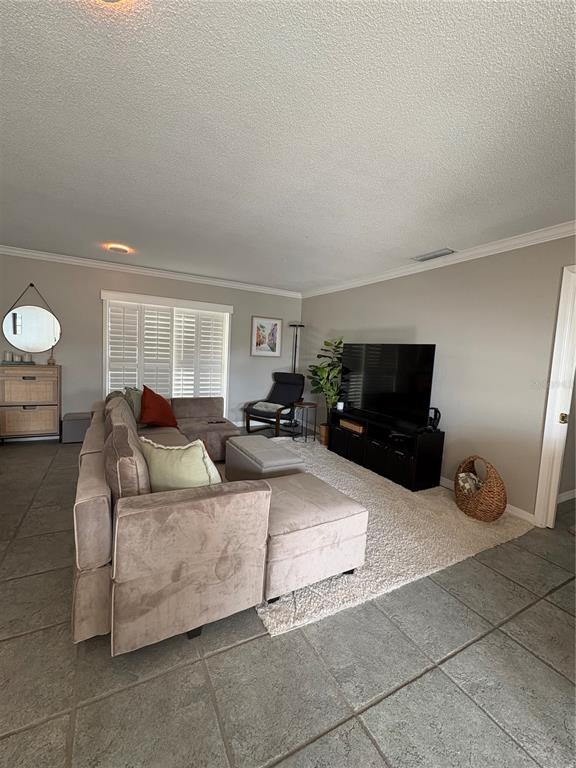 1500 Gay Road, Unit 20D Winter Park, FL 32789 - Photo 5 of 22 a living room with furniture and a flat screen tv