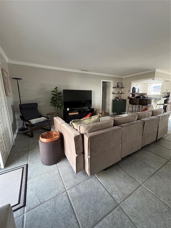 1500 Gay Road, Unit 20D Winter Park, FL 32789 - Photo 6 of 22 a living room with furniture a flat screen tv and a fireplace