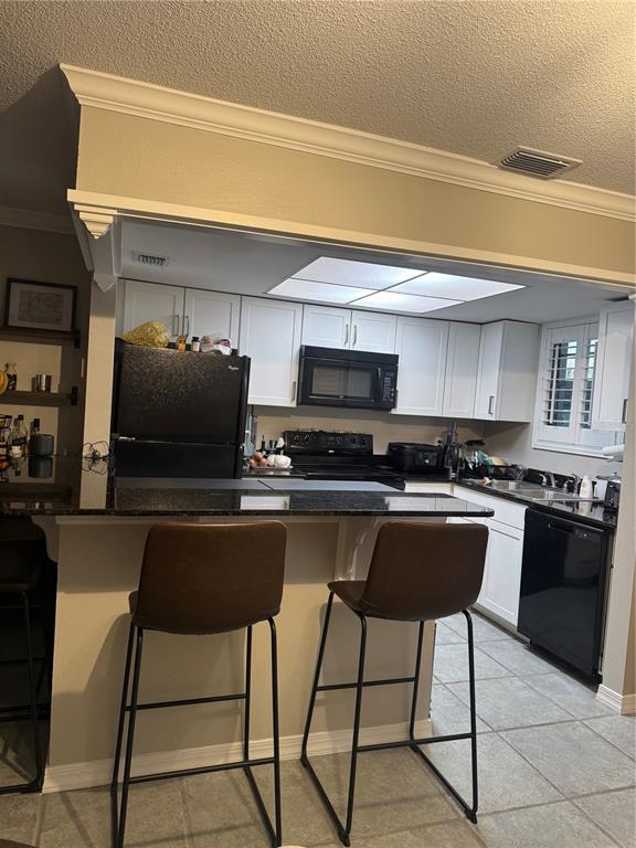 1500 Gay Road, Unit 20D Winter Park, FL 32789 - Photo 9 of 22 a kitchen with stainless steel appliances a stove a sink and a refrigerator