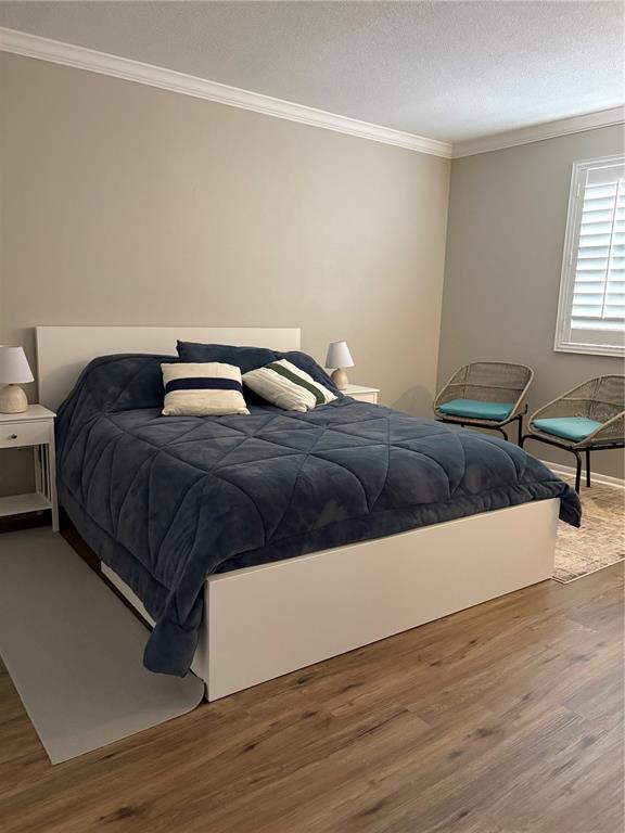 1500 Gay Road, Unit 20D Winter Park, FL 32789 - Photo 10 of 22 a bedroom with a bed and wooden floor