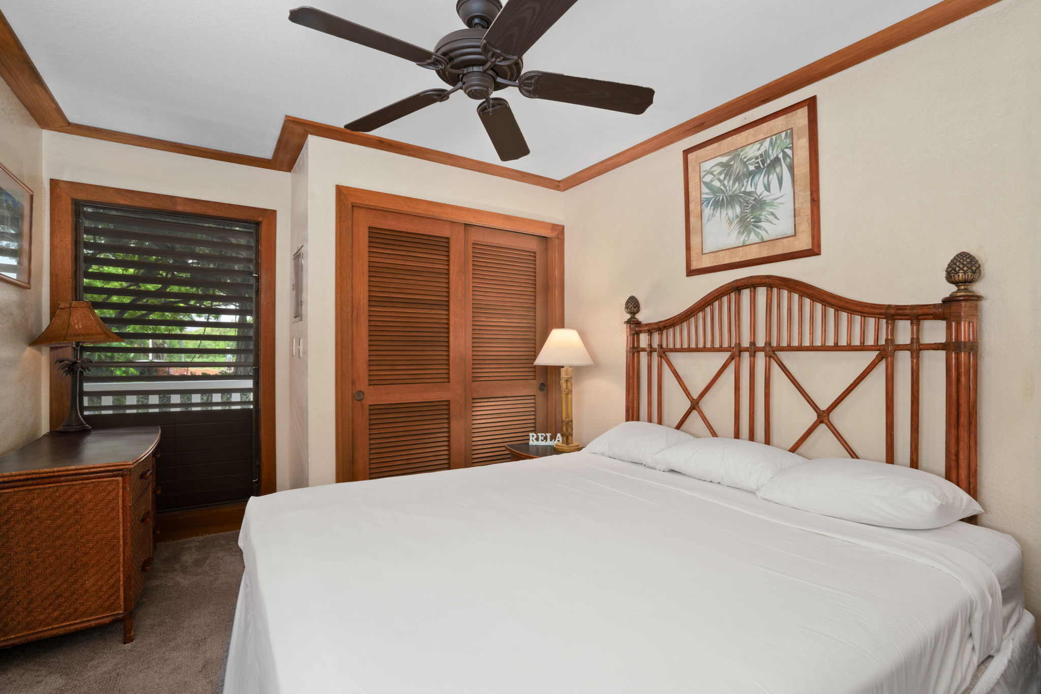 2253 Poipu Road, Unit 330 Koloa, HI 96756 - Photo 15 of 26 a bedroom with a large bed and a chandelier