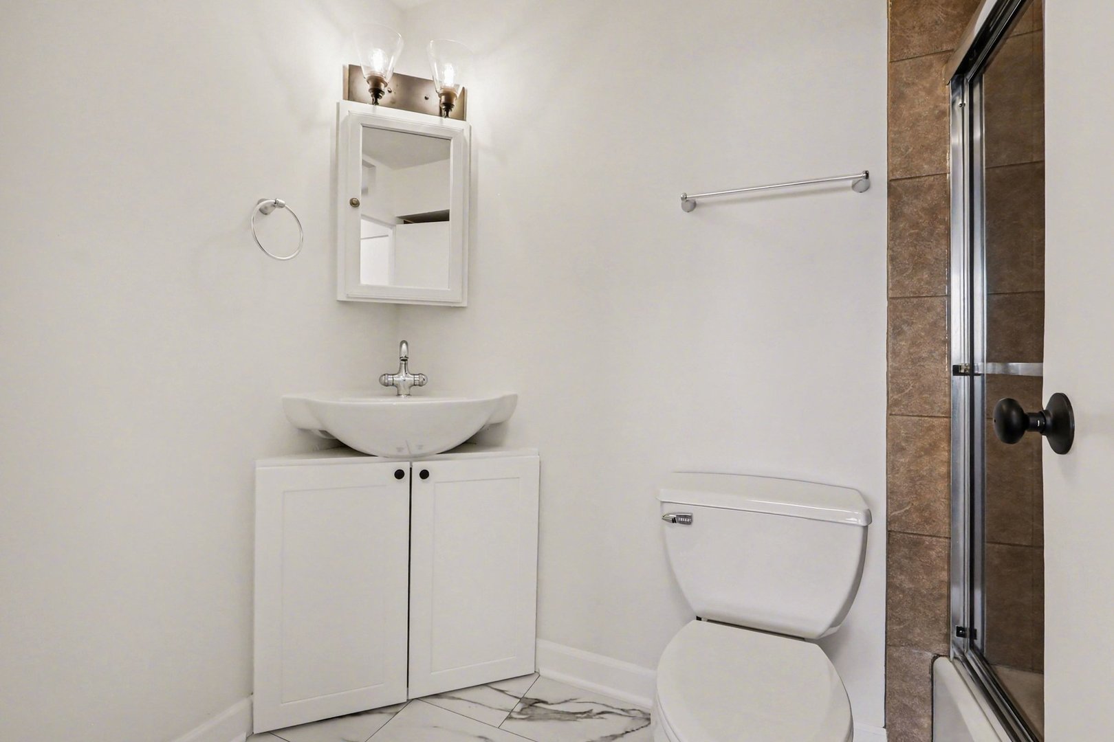 20 North Tower Road, Unit 4C Oak Brook, IL 60523 - Photo 15 of 16 a bathroom with a toilet a sink and mirror