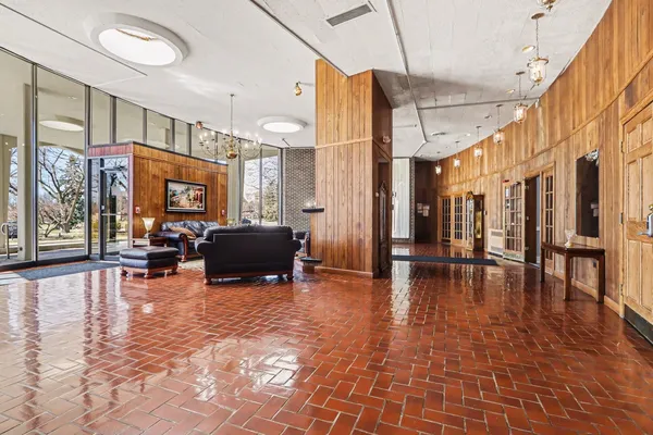 a lobby with furniture and floor to ceiling window