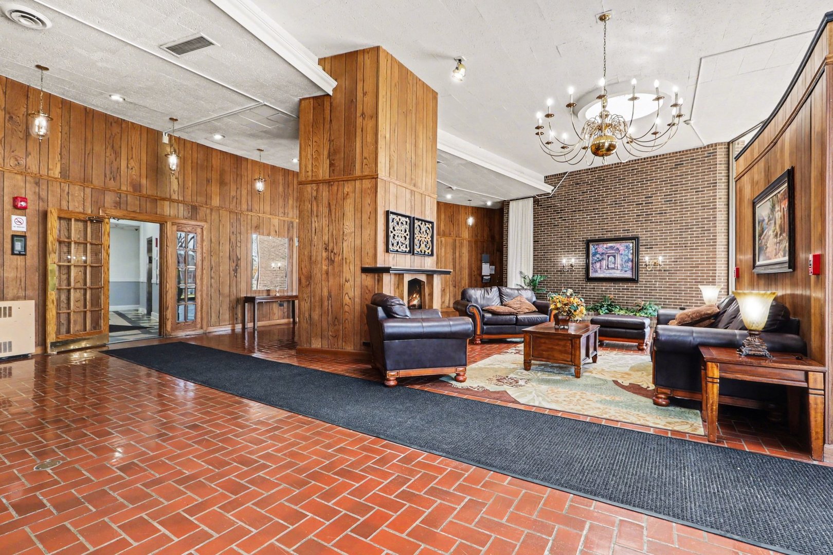 20 North Tower Road, Unit 4C Oak Brook, IL 60523 - Photo 3 of 16 a living room with patio furniture and a chandelier