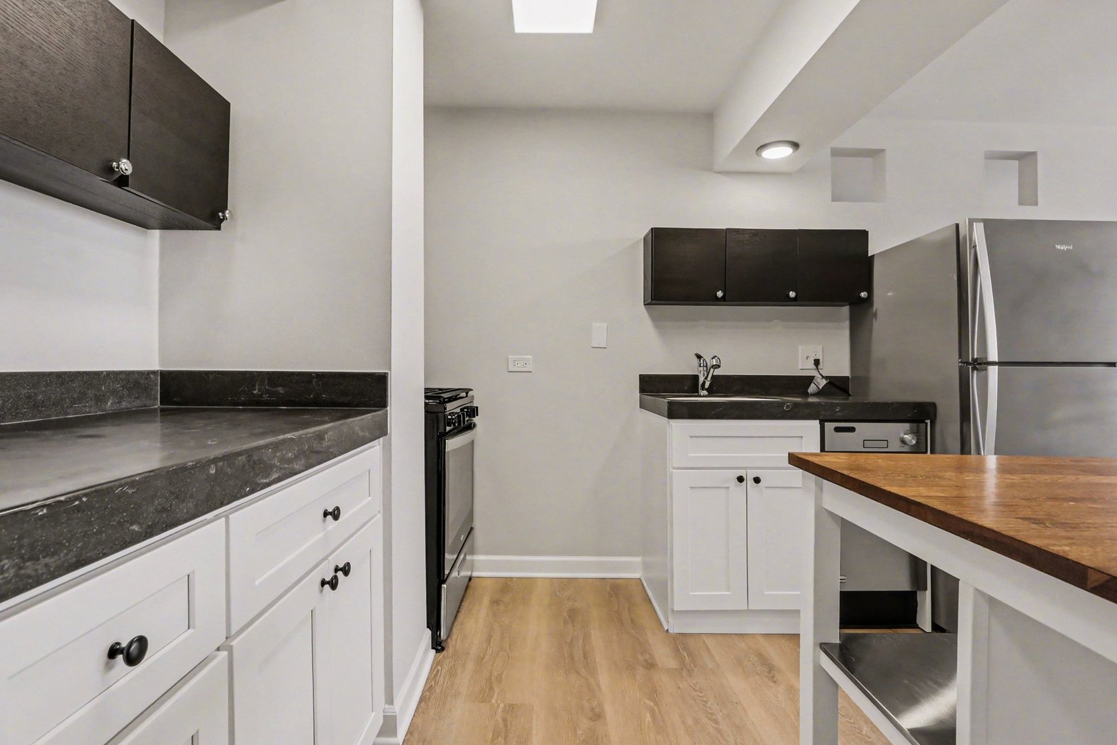20 North Tower Road, Unit 4C Oak Brook, IL 60523 - Photo 9 of 16 a kitchen with stainless steel appliances granite countertop a sink stove and refrigerator