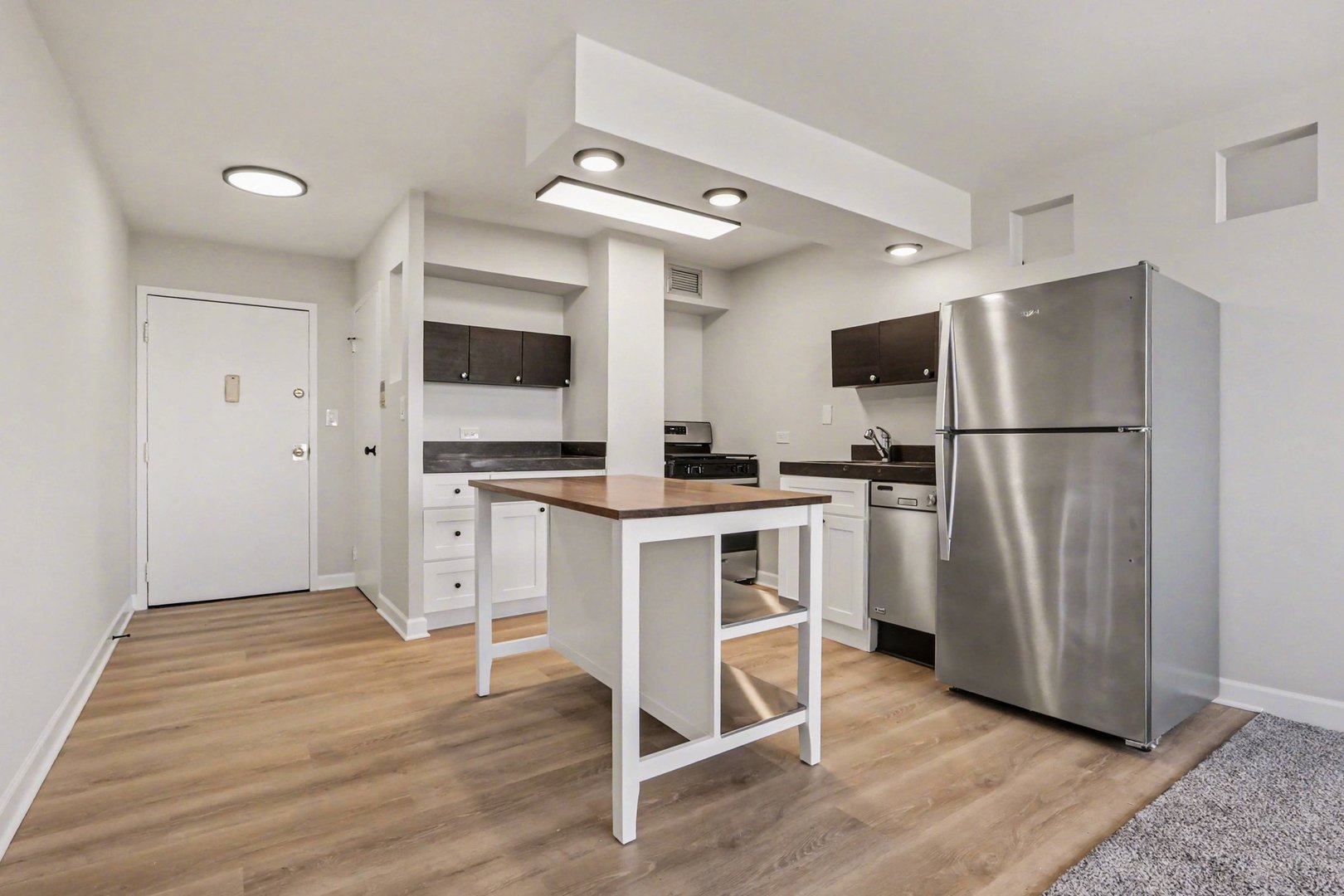 20 North Tower Road, Unit 4C Oak Brook, IL 60523 - Photo 10 of 16 a kitchen with white cabinets and stainless steel appliances