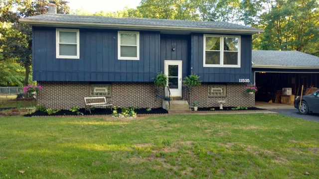a view of a house with a yard and sitting area