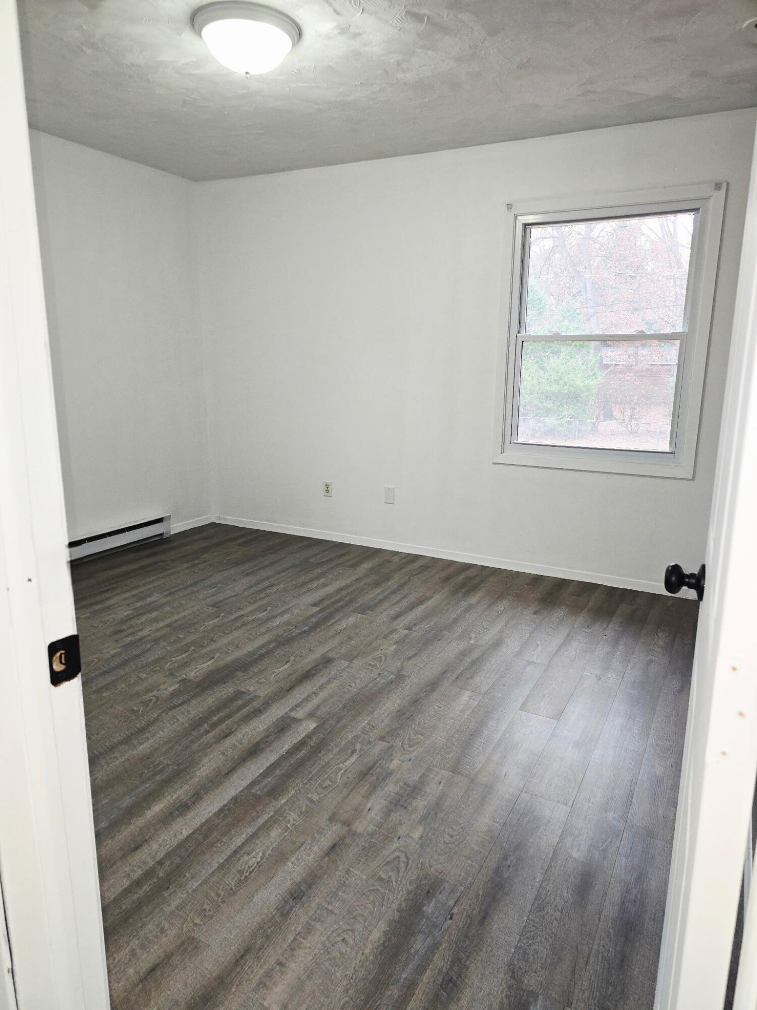 11535 Sandhill Trail Demotte, IN 46310 - Photo 22 of 31 an empty room with wooden floor and windows