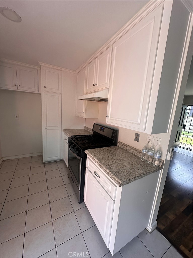 1440 North Weeping Willow Lane Anaheim, CA 92801 - Photo 18 of 31 a kitchen with a sink stove and cabinets