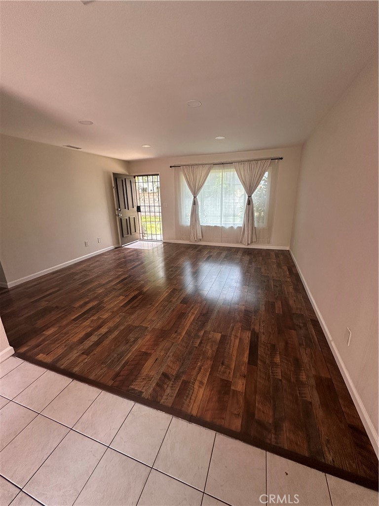 1440 North Weeping Willow Lane Anaheim, CA 92801 - Photo 5 of 31 an empty room with wooden floor and windows