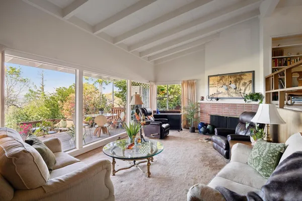 a living room with furniture and lots of windows