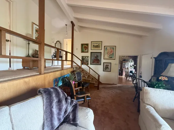 a living room with furniture fireplace and a large window