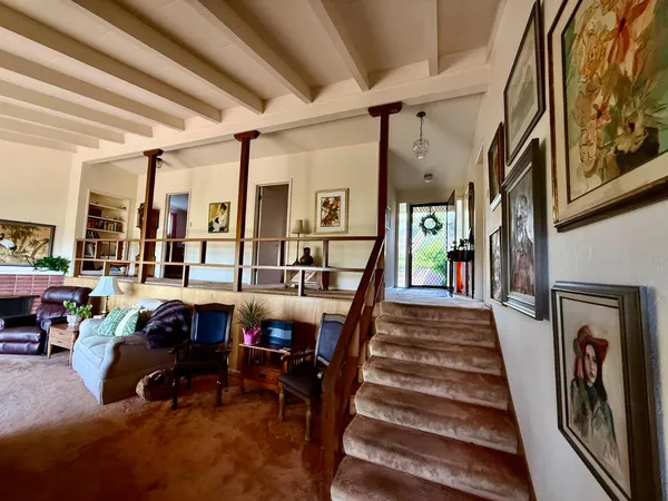 a view of a dining room with furniture and chandelier
