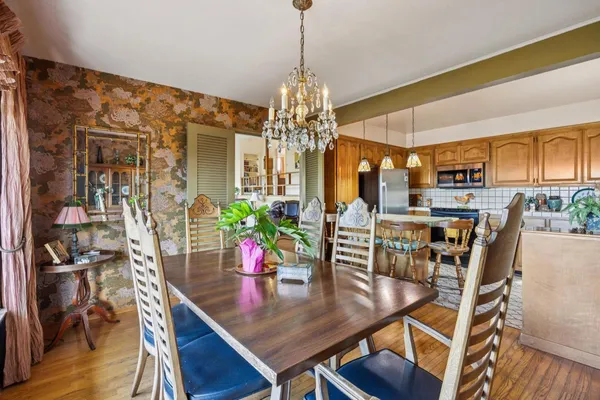 a kitchen with stainless steel appliances granite countertop a refrigerator a stove and a sink