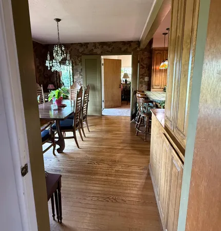a large kitchen with a table and chairs
