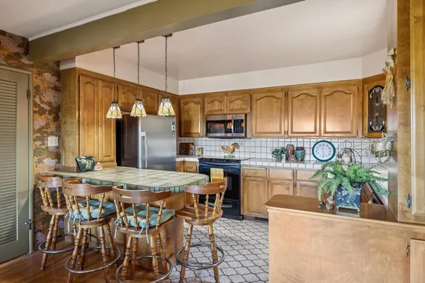 a kitchen with a sink window and cabinets