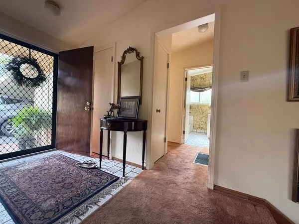 a living room with furniture a fireplace and a floor to ceiling window