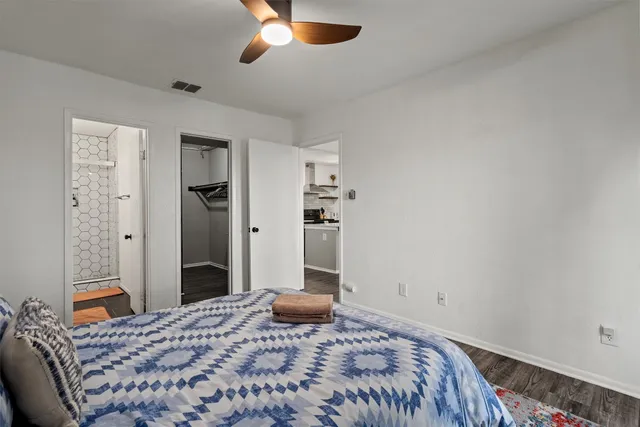 a bedroom with a bed and a chandelier