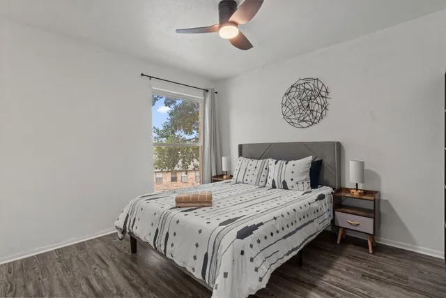 a bedroom with a bed and a window