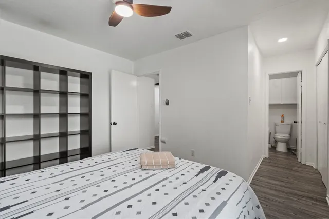 a bedroom with a bed and a dresser