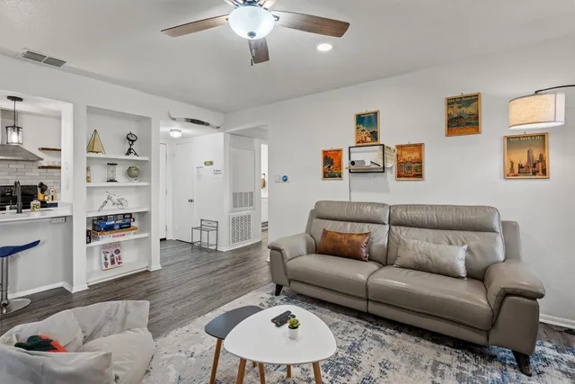 a living room with furniture and kitchen view
