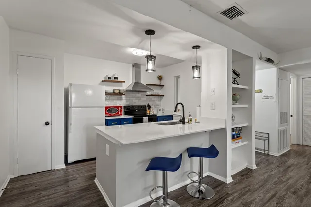 a kitchen with stainless steel appliances granite countertop a refrigerator and a stove top oven