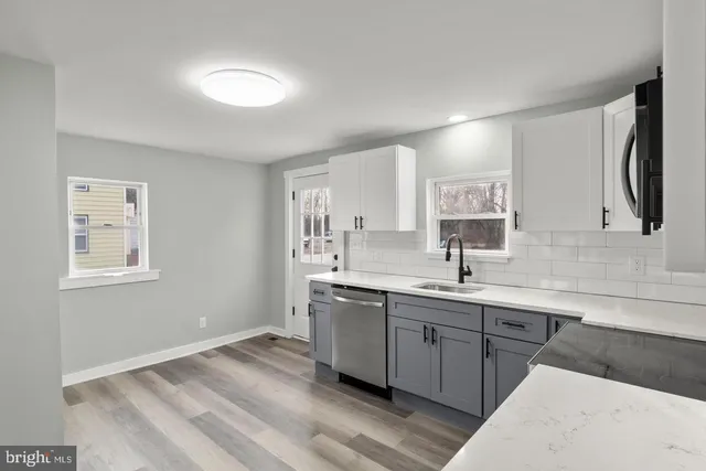 a kitchen with a sink cabinets and window