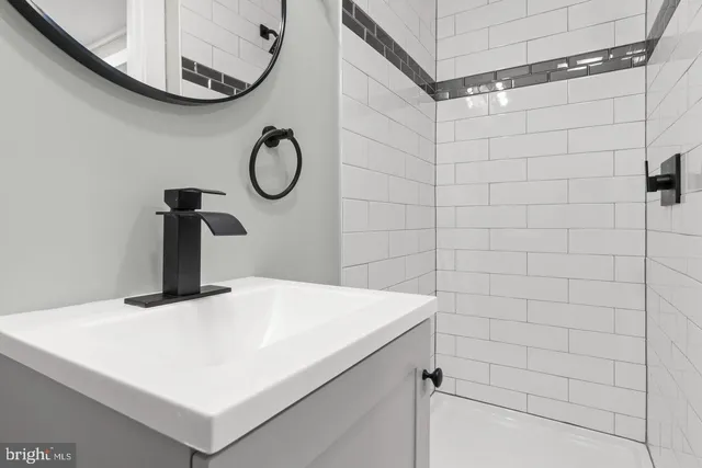 a bathroom with a sink and mirror