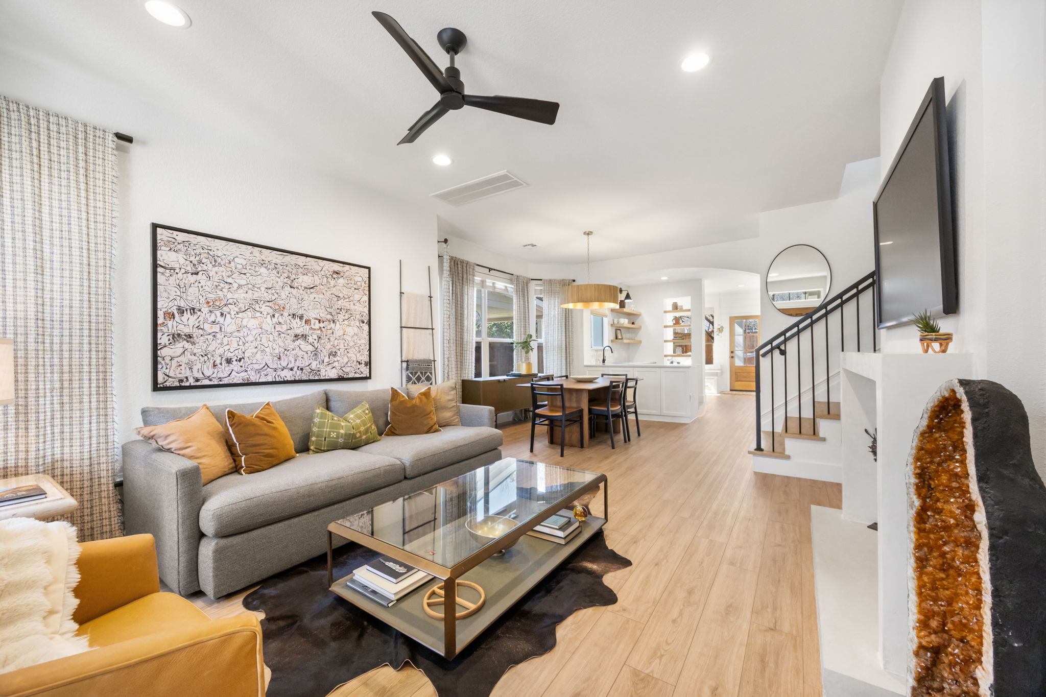 a living room with furniture and wooden floor