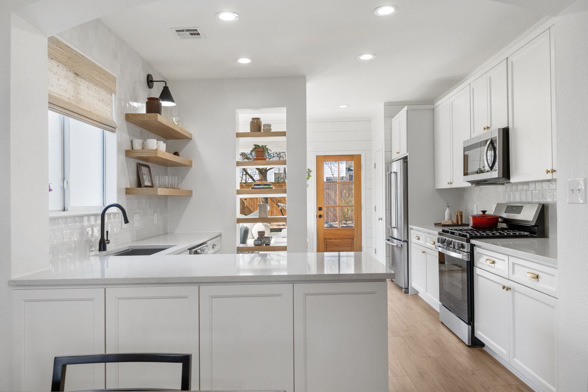 2510 Thornton Road Austin, TX 78704 - Photo 8 of 40 a kitchen with stainless steel appliances granite countertop a sink stove and cabinets