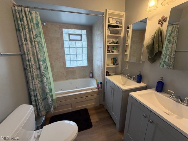 35180 Solon Road Solon, OH 44139 - Photo 20 of 33 Full bathroom with two vanities, dark wood-style floors, and a combined bath / shower with jetted tub
