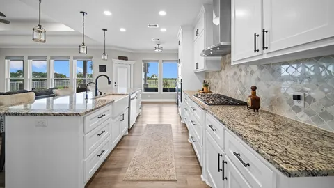 a large kitchen with kitchen island granite countertop a large counter top